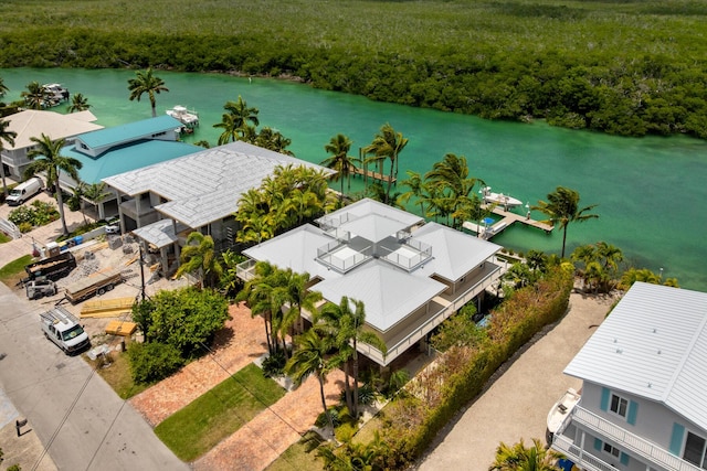 drone / aerial view of a heavily wooded area and a large body of water