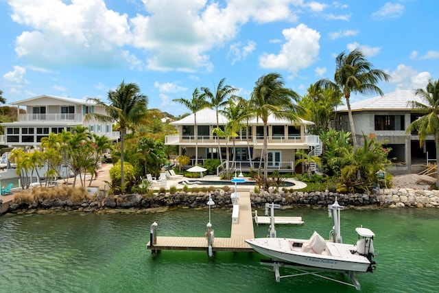 dock area featuring a water view and a balcony