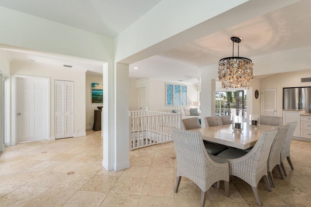 dining area with a chandelier, ornamental molding, and baseboards