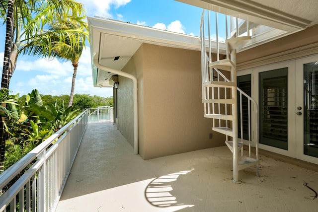 view of patio featuring a balcony and french doors