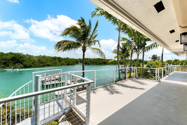 dock featuring a water view and a balcony