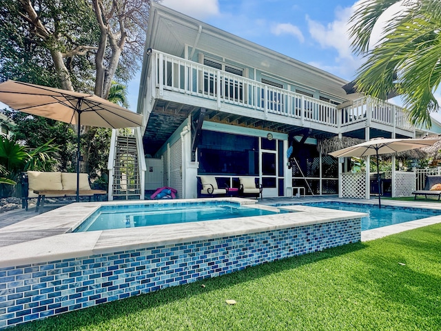 164 Tortuga Ln, Cudjoe, FL 33042 - back of house with a yard, stairs, a patio, a balcony, and an outdoor pool