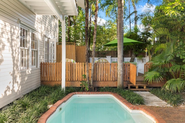 view of swimming pool with a deck