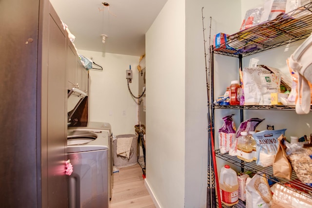 clothes washing area with light hardwood / wood-style floors