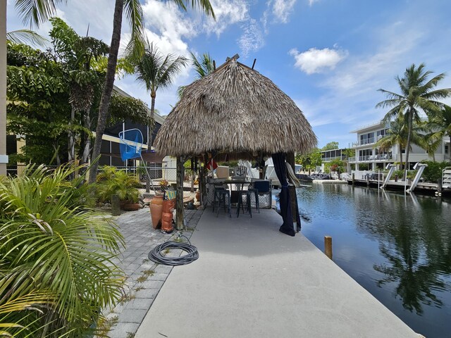 19 N Dr, Key Largo, FL 33037 - dock area featuring a water view, a gazebo, outdoor dining space, and a patio area