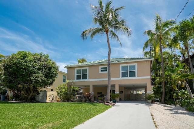 19 N Dr, Key Largo, FL 33037 - view of front of home with a carport, stucco siding, driveway, and a tiled roof