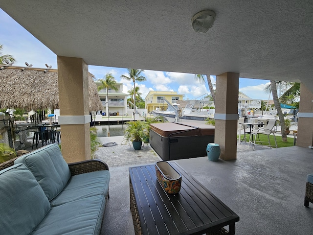 19 N Dr, Key Largo, FL 33037 - view of patio / terrace featuring a hot tub, an outdoor hangout area, and a residential view