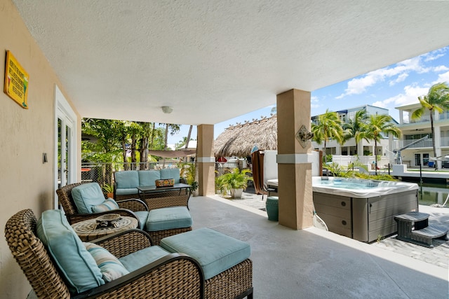 19 N Dr, Key Largo, FL 33037 - view of patio / terrace featuring a hot tub, an outdoor living space, and a residential view