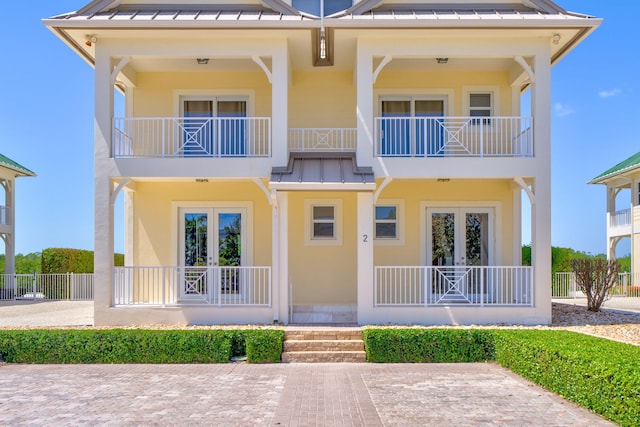 2394 Coco Plum Dr Unit 2, Marathon, FL 33050 - view of front of property with a standing seam roof, a metal roof, a balcony, a porch, and stucco siding