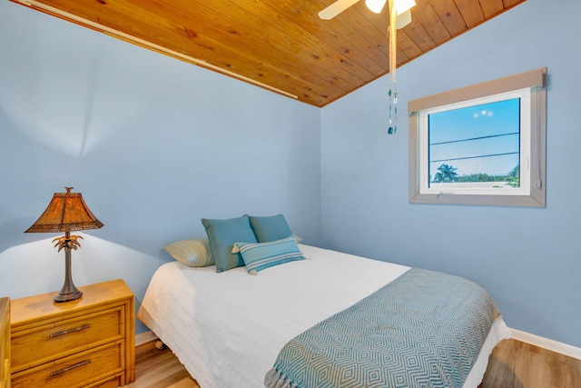 bedroom with vaulted ceiling, ceiling fan, wooden ceiling, and light wood-type flooring