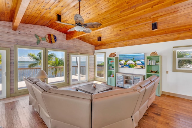 living room with vaulted ceiling with beams, light hardwood / wood-style floors, and wooden ceiling