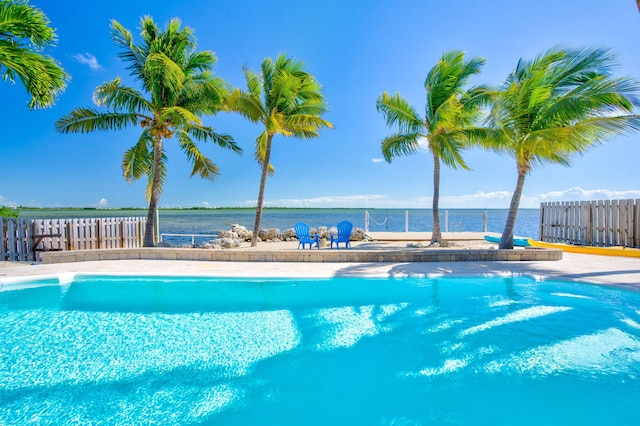 view of swimming pool featuring a water view