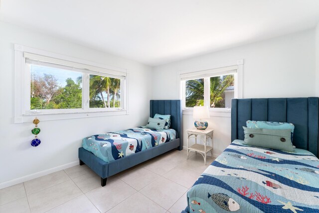 bedroom featuring multiple windows and light tile patterned floors