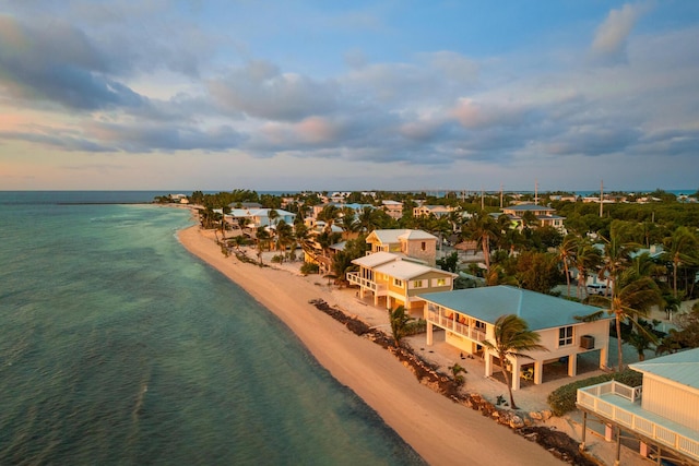 drone / aerial view featuring a water view and a beach view