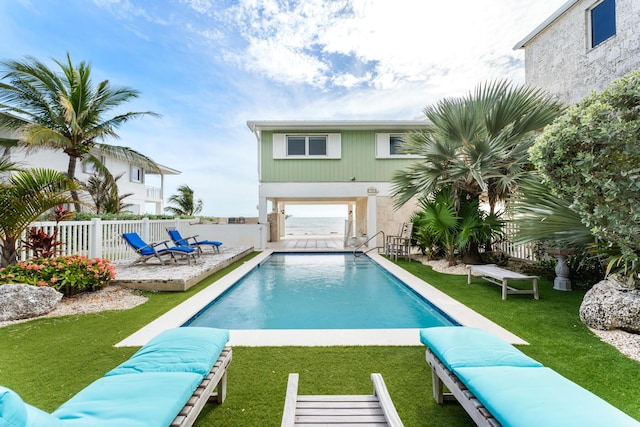 view of pool featuring a yard