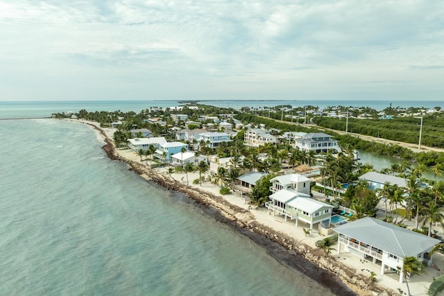 bird's eye view featuring a water view and a view of the beach