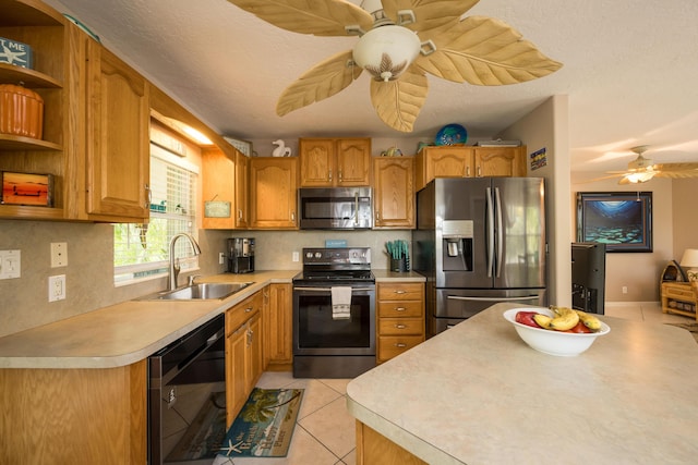 kitchen featuring light tile patterned flooring, tasteful backsplash, sink, ceiling fan, and stainless steel appliances