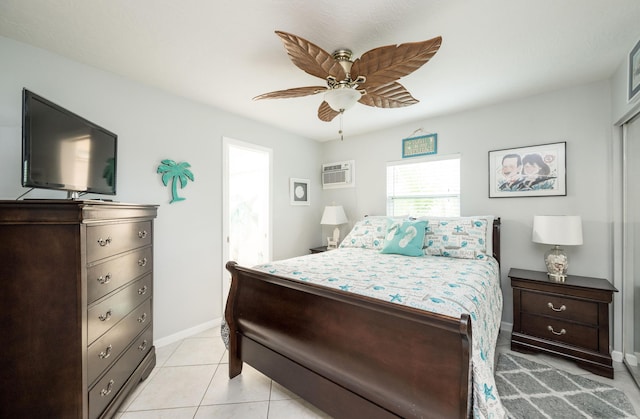 bedroom featuring light tile patterned flooring, ceiling fan, and an AC wall unit