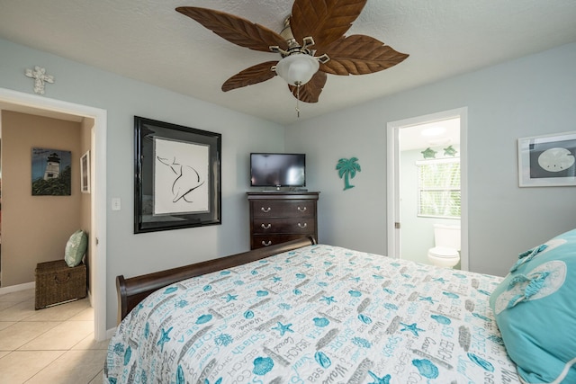 tiled bedroom featuring ceiling fan and ensuite bathroom