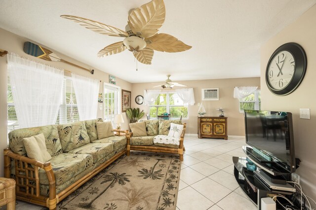 tiled living room featuring a wall mounted air conditioner and ceiling fan