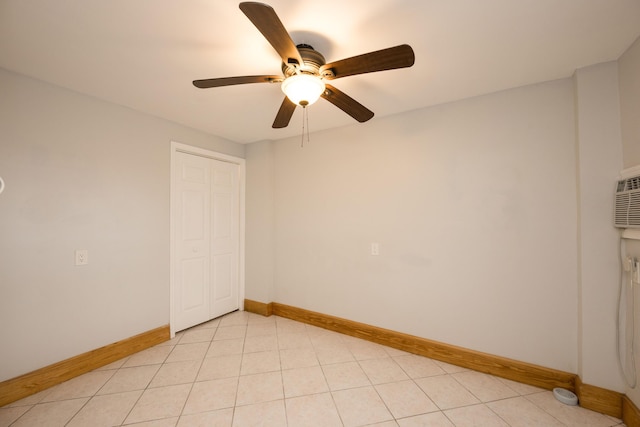 empty room featuring light tile patterned flooring and ceiling fan