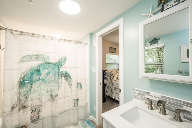 bathroom with tasteful backsplash and vanity