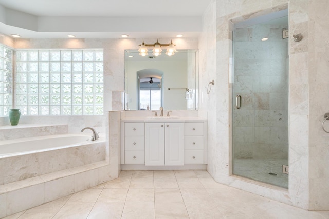 bathroom featuring vanity, tile patterned floors, and shower with separate bathtub