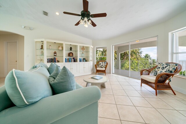 tiled living room featuring vaulted ceiling and ceiling fan