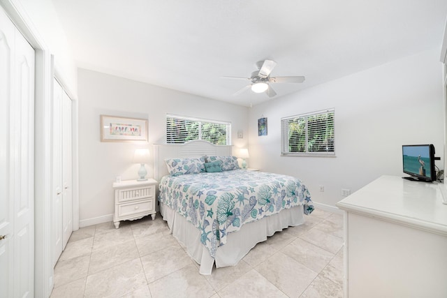 tiled bedroom featuring ceiling fan