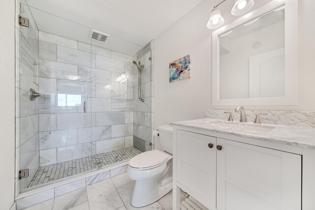 bathroom with walk in shower, vanity, and toilet