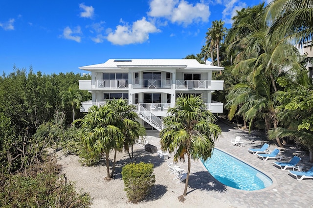 back of property with a patio and a balcony