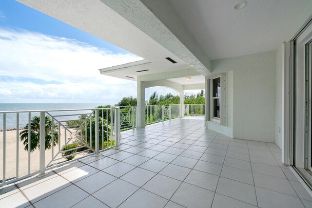 view of patio / terrace with a balcony and a water view