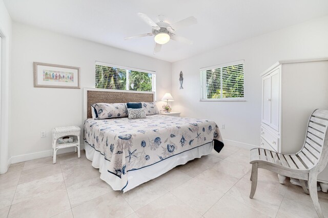 bedroom featuring light tile patterned floors and ceiling fan