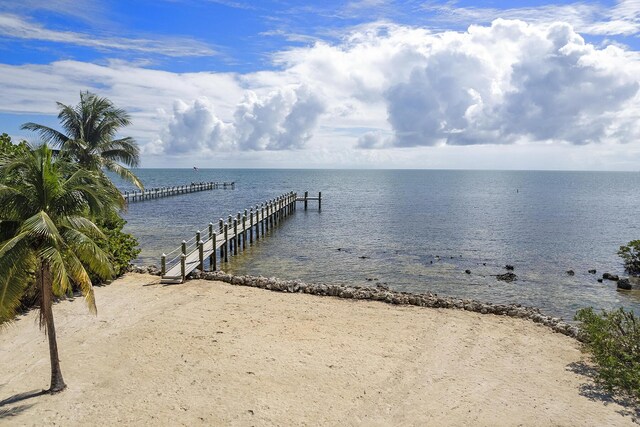 dock area featuring a water view and a view of the beach