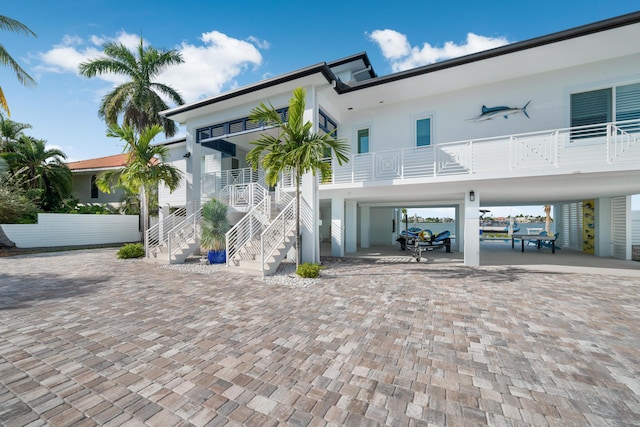 16745 Tamarind Rd, Sugarloaf, FL 33042 - back of property featuring a carport, stairs, and driveway