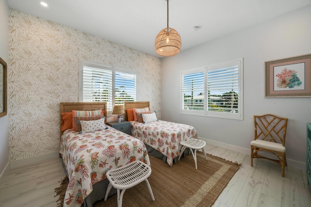 16745 Tamarind Rd, Sugarloaf, FL 33042 - bedroom featuring wallpapered walls, multiple windows, baseboards, and wood finished floors