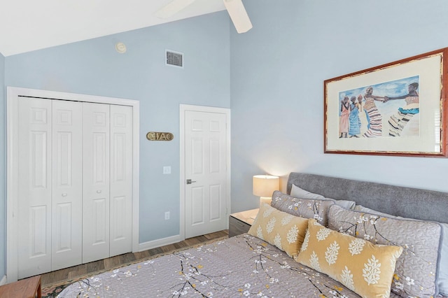 bedroom featuring ceiling fan, wood finished floors, visible vents, baseboards, and a closet