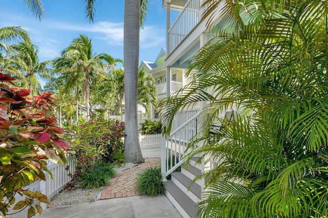 view of home's exterior with a balcony and fence