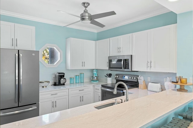 kitchen with appliances with stainless steel finishes, decorative backsplash, and white cabinets