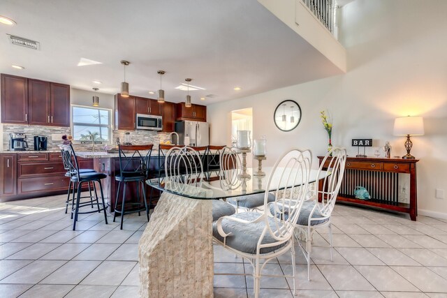 dining space featuring light tile patterned floors