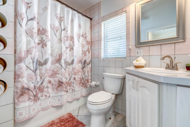 full bathroom with shower / tub combo with curtain, tile patterned floors, toilet, tile walls, and vanity