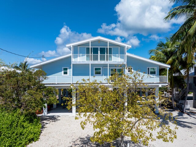 view of front of property with a carport and a balcony