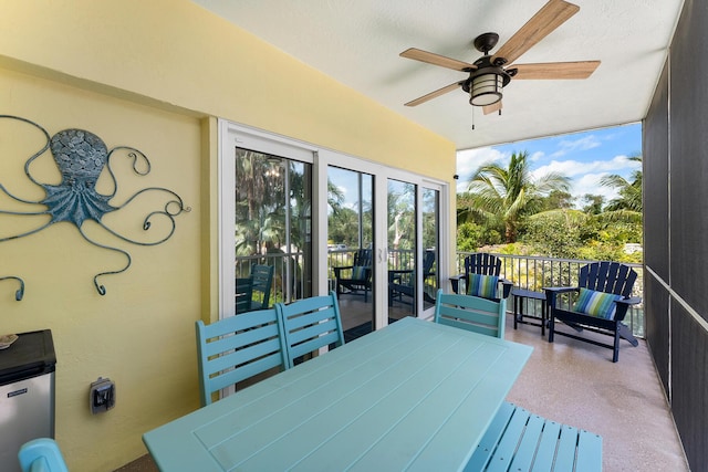 sunroom / solarium featuring ceiling fan