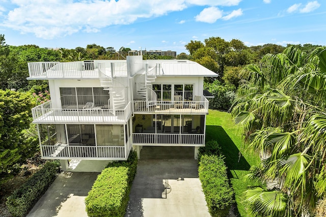 back of property with a balcony and a yard