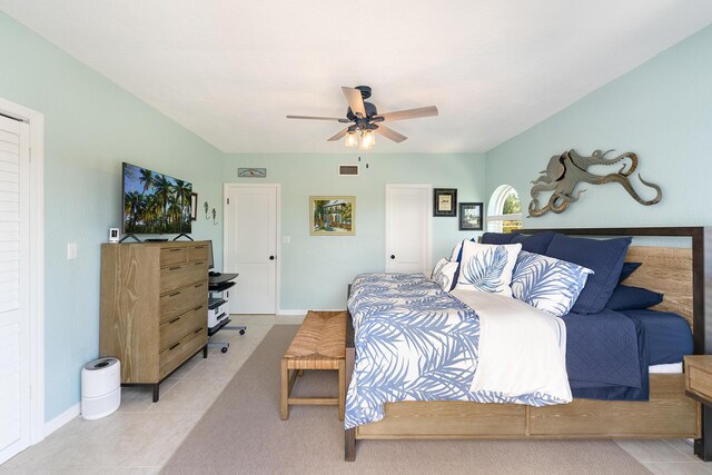 bedroom featuring light tile patterned floors and ceiling fan