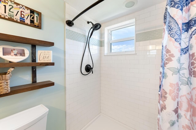 bathroom featuring toilet and walk in shower