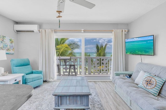 living room with a wall mounted air conditioner, light hardwood / wood-style floors, and ceiling fan