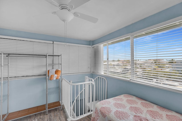 bedroom with wood finished floors and a ceiling fan