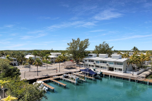 view of dock with a residential view and a water view