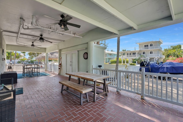 view of patio / terrace with outdoor dining space, fence, and a ceiling fan